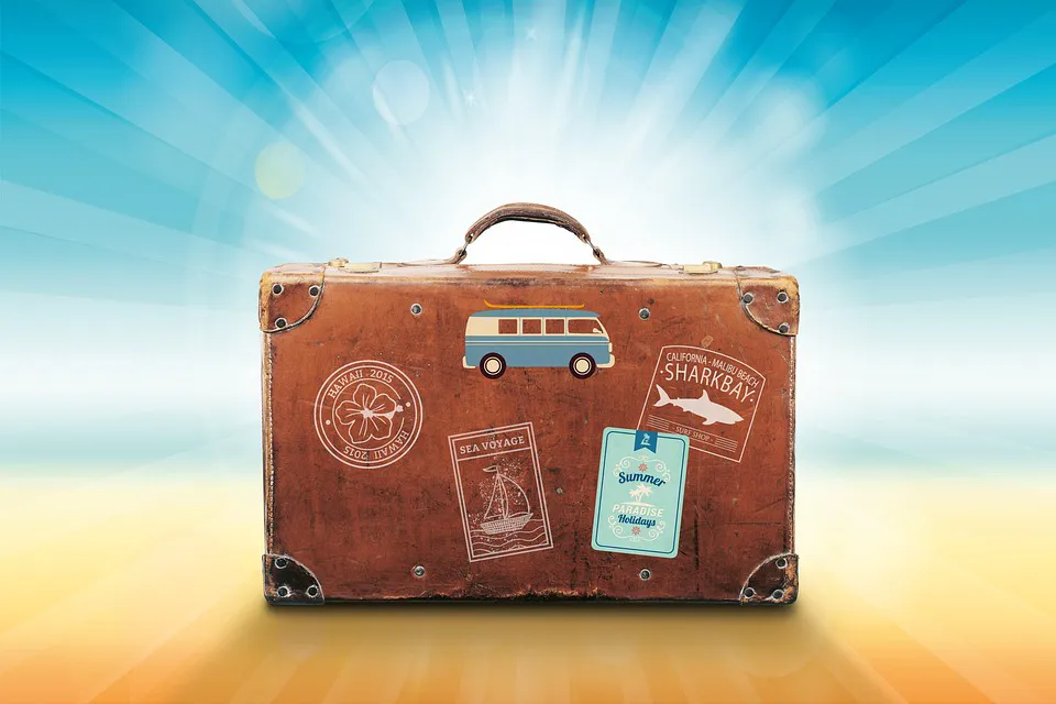 Suitcase covered in travel stickers on a bright background