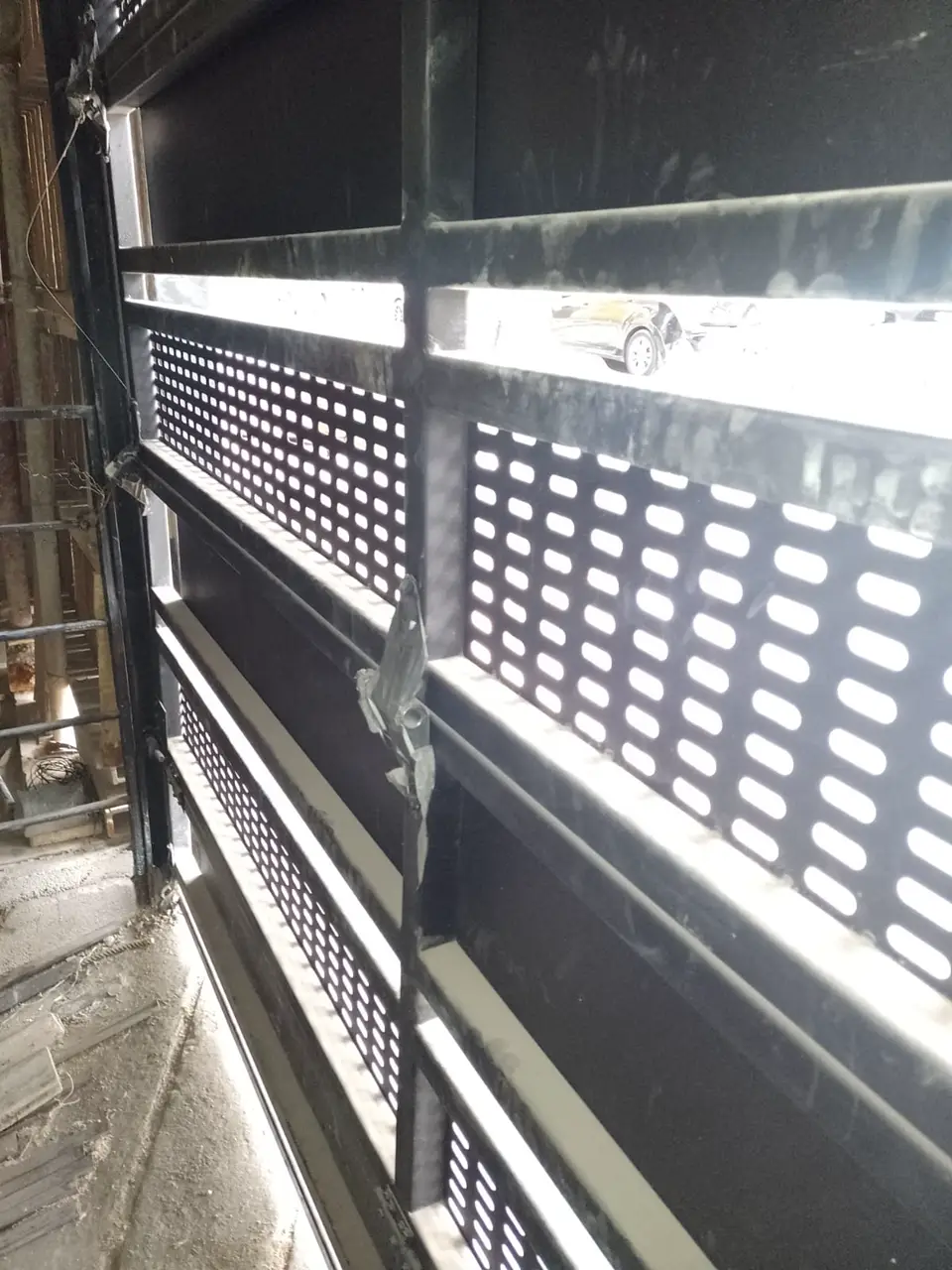 Perforated black metal panel on a facade