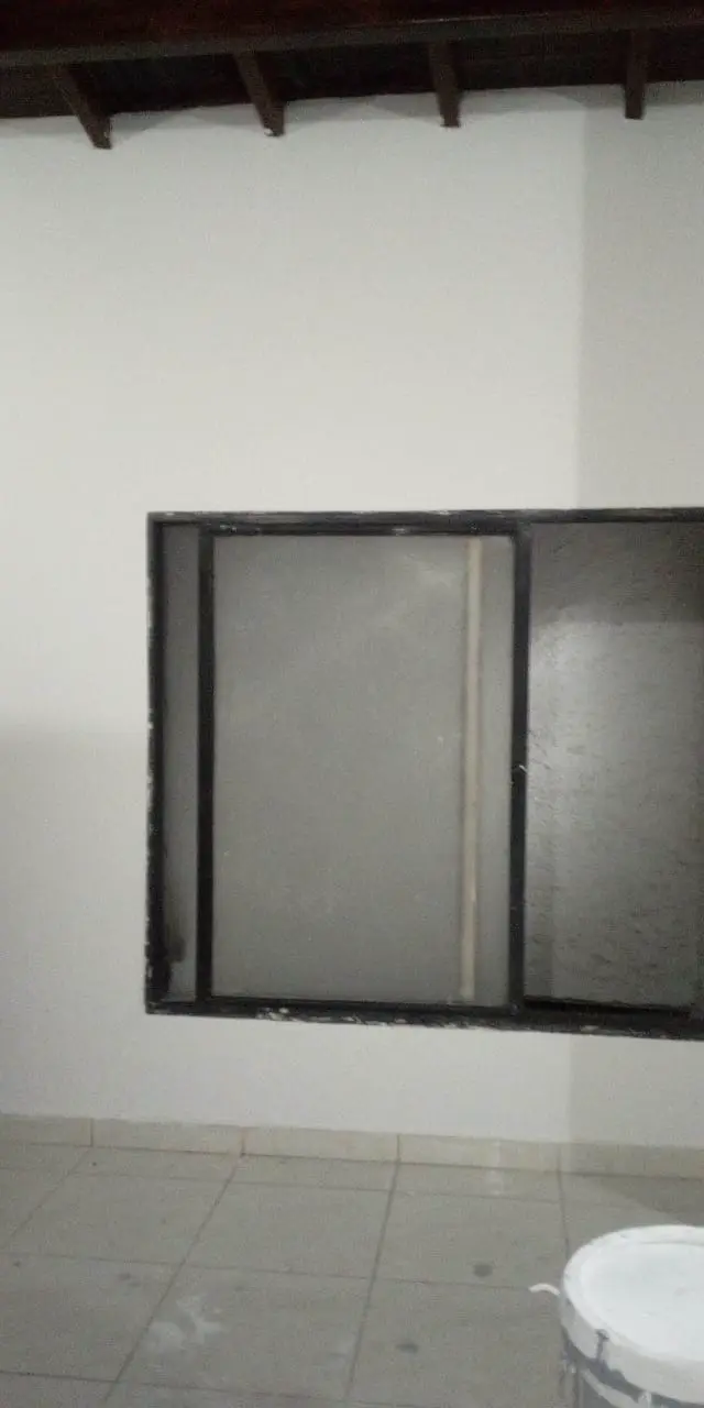 White room with a dark-framed window