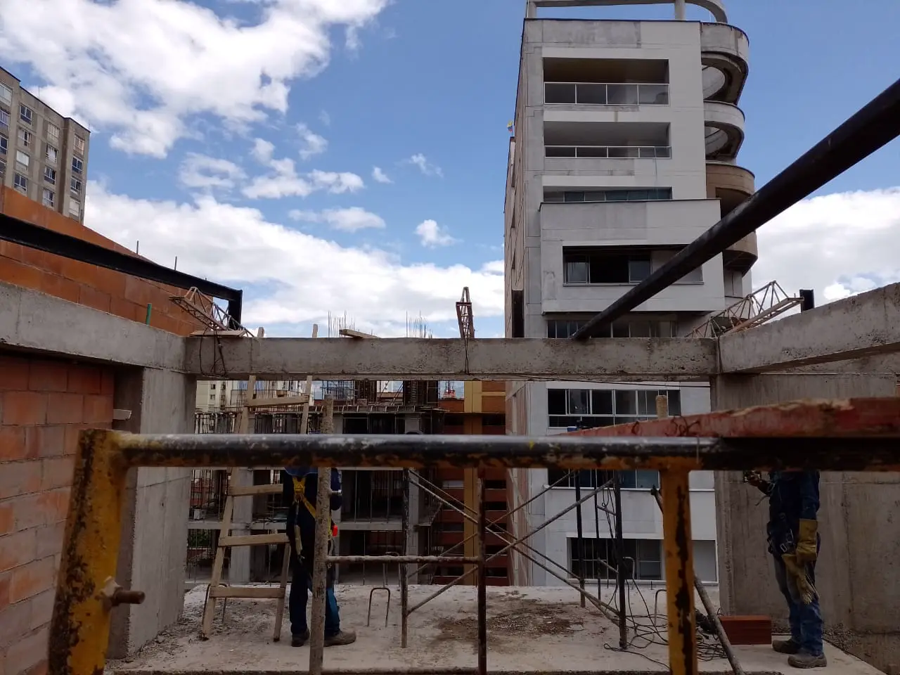 Building under construction with concrete columns and scaffolding