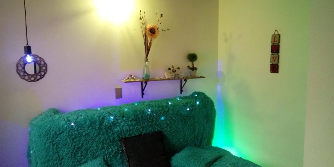 Living room with decorative lighting and a green sofa