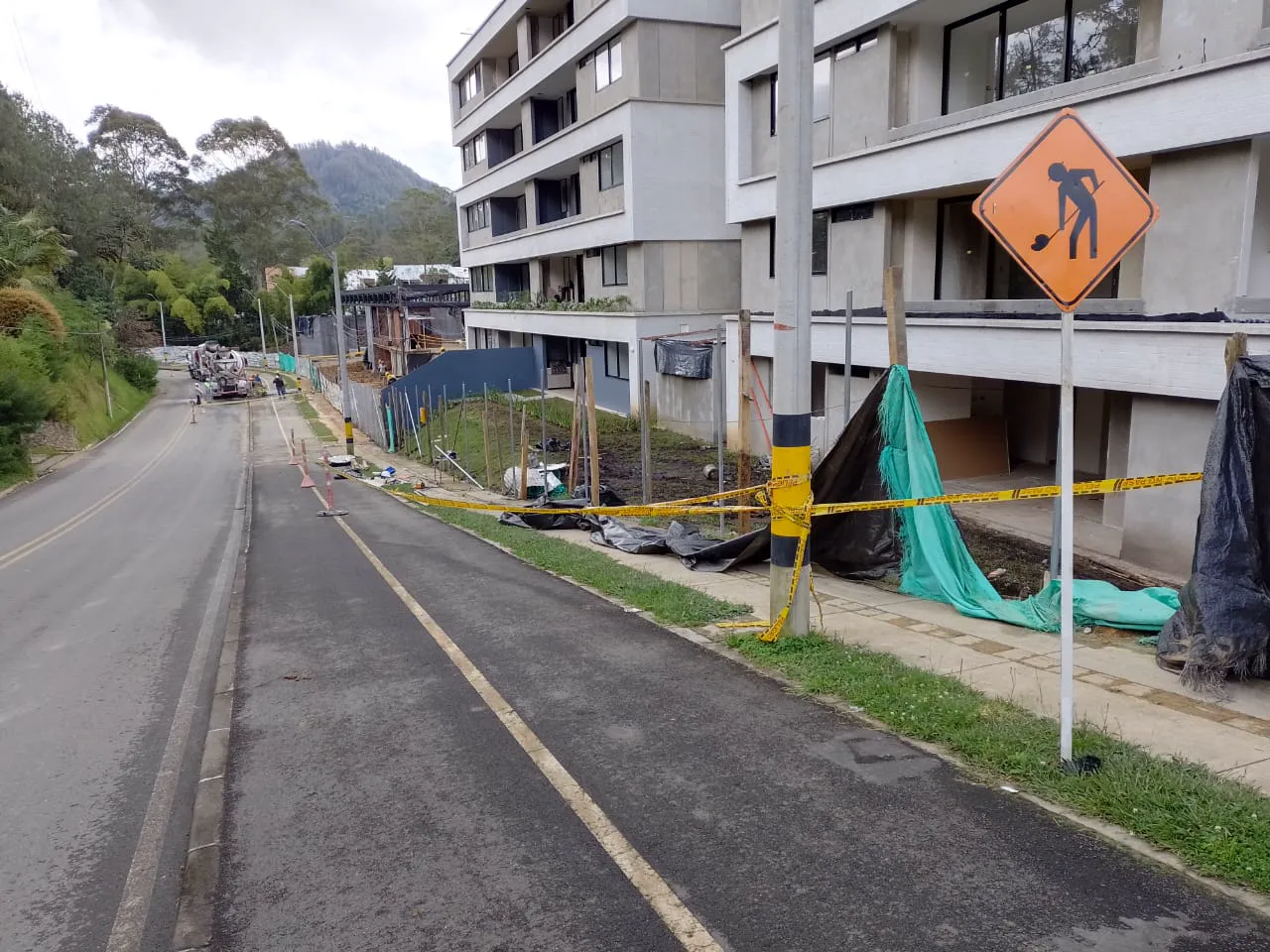 Road works with machinery next to a building