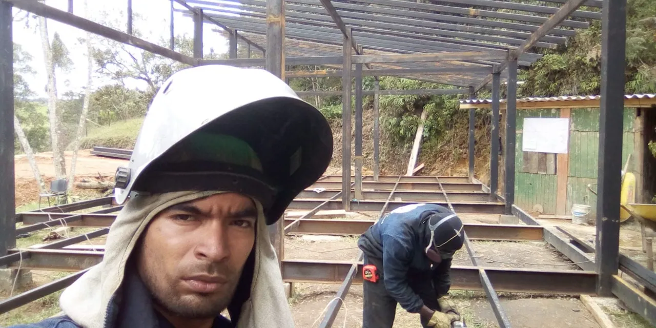 Workers welding a metal roof structure