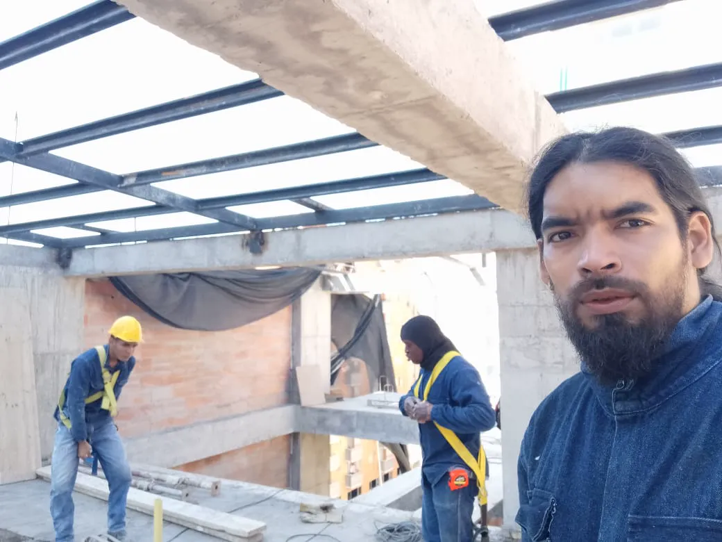 Roof structure under construction with workers on site